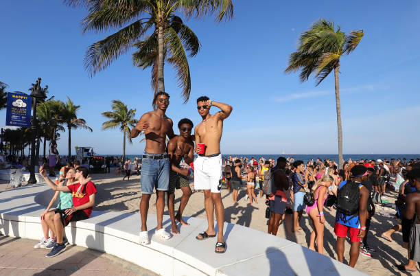 3人の若い男性が浜辺でポーズをとる。 - fort lauderdale fort florida beach ストックフォトと画像
