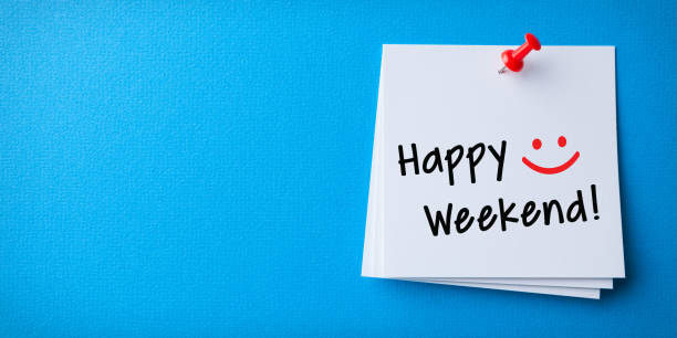 White Sticky Note With Happy Weekend And Red Push Pin On Blue Background stock photo