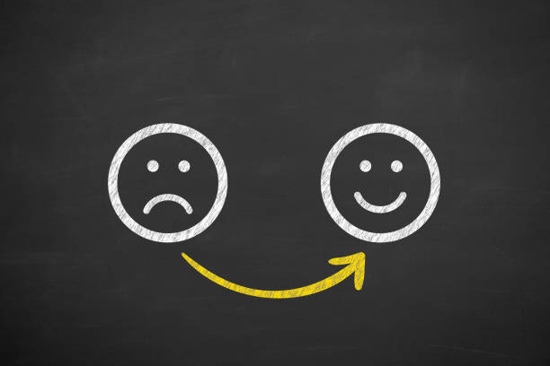 Unhappy and Happy on Blackboard Background