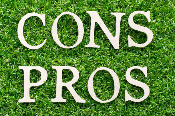istock Wood alphabet in word pros cons on artificial green grass background 1210872493