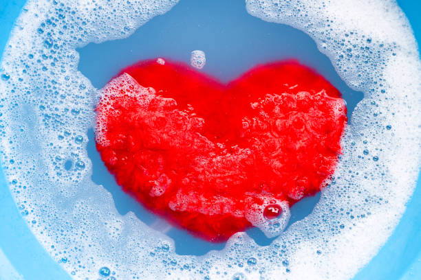istock Soaking heart red pillow in laundry detergent water dissolution before washing.  Laundry concept, 1210876288