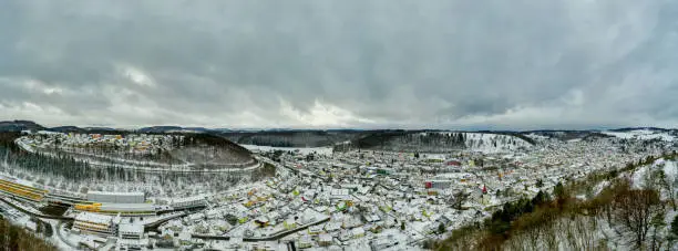 Albstadt, snow city at the Schwaebische Alb of germany in white powdered winter landscape aerial scene from a drone.