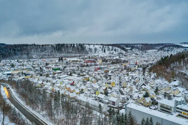 Albstadt, snow city at the Schwaebische Alb of germany in white powdered winter landscape aerial scene from a drone.