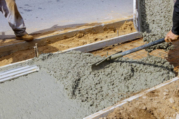istock Construction worker pour cement for sidewalk in new residential home 1210882534