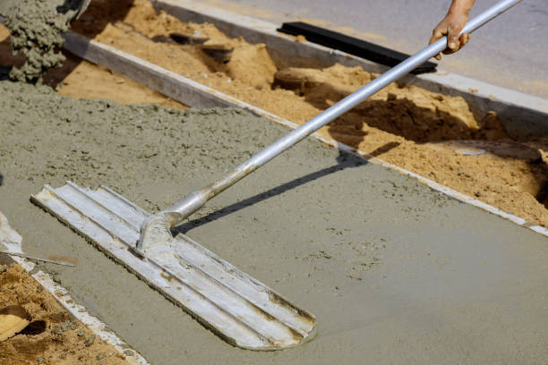 istock Construction workers laying concrete mixer with concrete mixer on sidewalk 1210882535