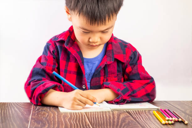 istock A little boy sitting at his desk doing his homework 1210883379