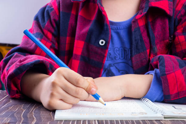 istock A little boy sitting at his desk doing his homework 1210883390