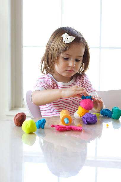 istock Girl playing with play dough 121088598