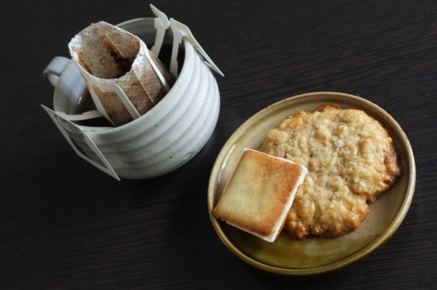 Instant freshly brewed cup of coffee,Drip bag fresh coffee served with cream crackers .  copy space for text insertion