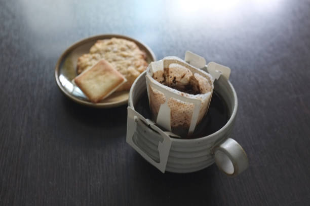 Instant freshly brewed cup of coffee,Drip bag fresh coffee served with cream crackers .  copy space for text insertion