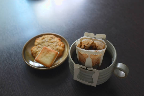 Instant freshly brewed cup of coffee,Drip bag fresh coffee served with cream crackers .  copy space for text insertion