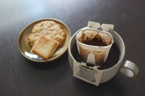 Instant freshly brewed cup of coffee,Drip bag fresh coffee served with cream crackers .  copy space for text insertion
