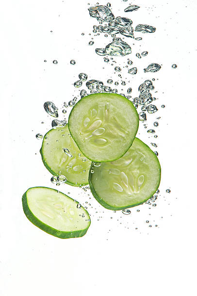 Cucumber segments in water stock photo