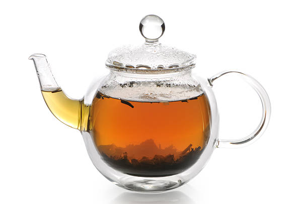istock Teapot with green tea on a white background 121089196