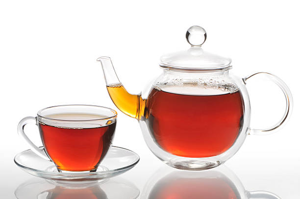 istock Teapot and cup with black tea on a white background 121089207