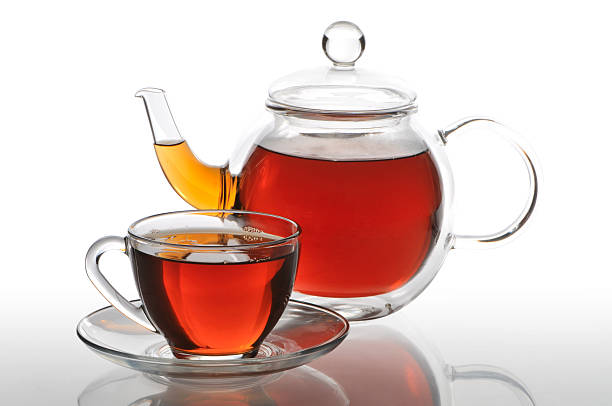 istock Teapot and cup with black tea on a white background 121089213