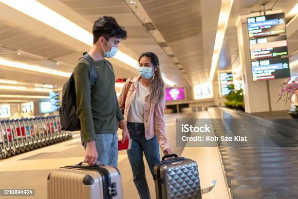 Masked Travelers At The Airport Stock Photo - Download Image Now - Airport, Flying, COVID-19