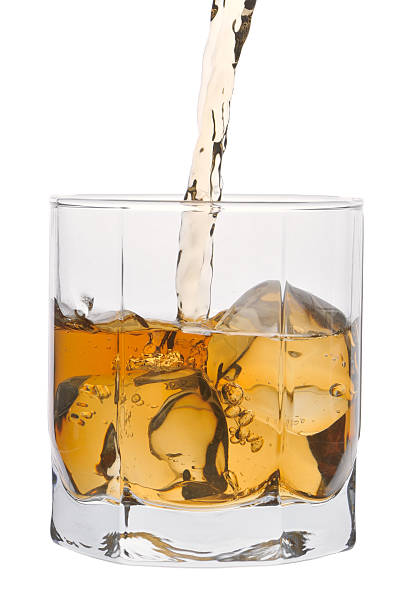istock Stream of whisky falling in glass with ice 121089667