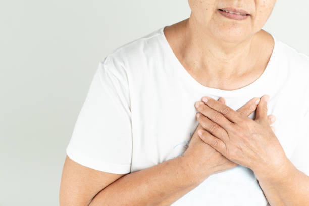istock Old woman heart attack holding breast on white background 1210897651