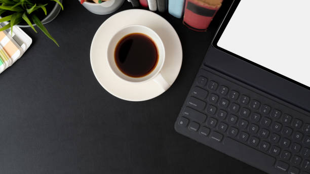 istock Top view of trendy workspace with mock-up tablet, coffee cup, books and copy space 1210904732
