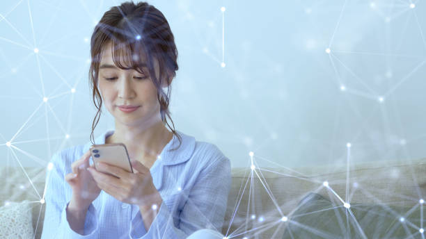 istock Wireless communication network concept. Mobile technology.Young asian woman using a smart phone. 1210907008