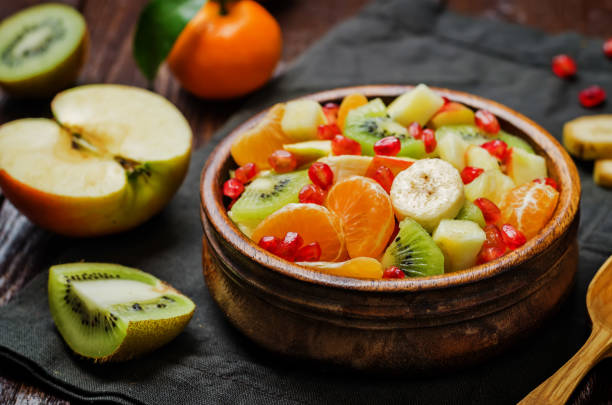 istock Healthy fruit salad on wood background 1210907933