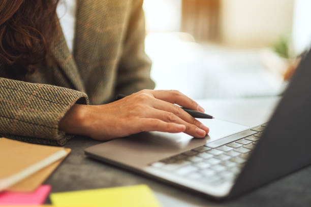 istock Businesswoman writing and typing on laptop computer on the table 1210907976