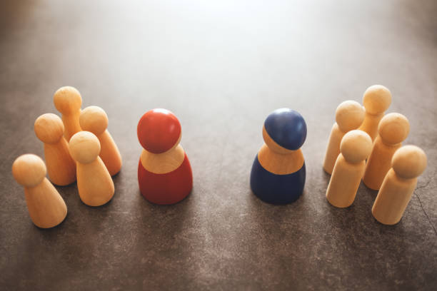 istock Two different groups of people standing facing to each other for business concept 1210907989