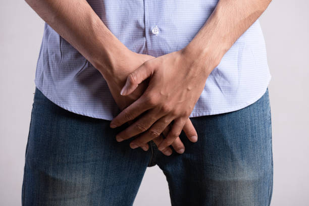 a young man suffering from prostatitis or from a venereal disease. healthcare concept. - venereal imagens e fotografias de stock