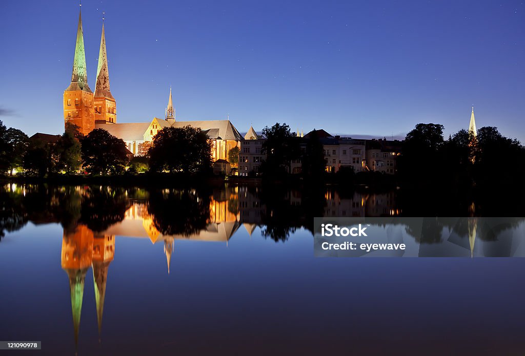 Lubeck Cathedral at night Lubeck Cathedral illuminated at night, reflected in the Trave river Lübeck Stock Photo