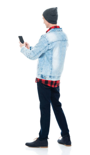 istock Caucasian young male hipster standing in front of white background wearing boot and using smart phone 1210910855