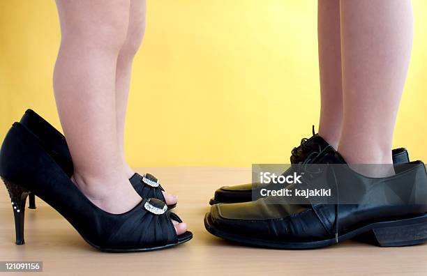 Childrens Feet In The Shoes Of Adults Stock Photo - Download Image Now - Shoe, Child, Large