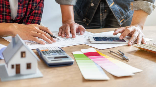 istock Interior designer and Architect choosing color in color swatch samples chart for house coloring selection in office with blueprint. Construction concept. 1210912942
