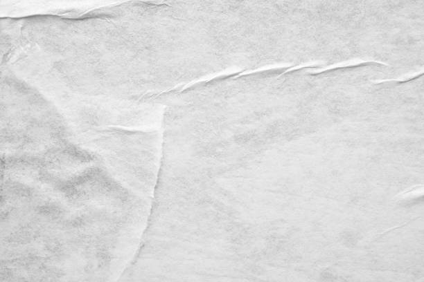 istock Blank white crumpled and creased paper poster texture background 1210912988