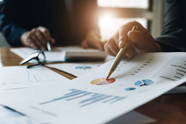 business team two colleagues discussing new plan financial graph data on office table with laptop and digital tablet. - growth plan graph digital tablet imagens e fotografias de stock