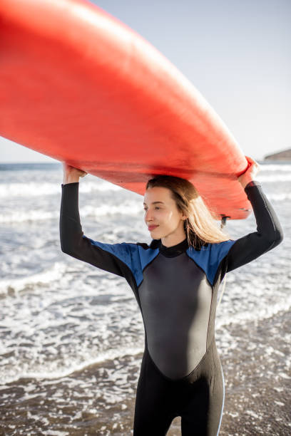 istock Young surfer with surfboard on the beach 1210915155