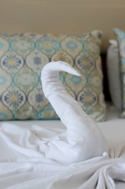 istock Beautiful swan from bath towel on hotel bed 1210915610