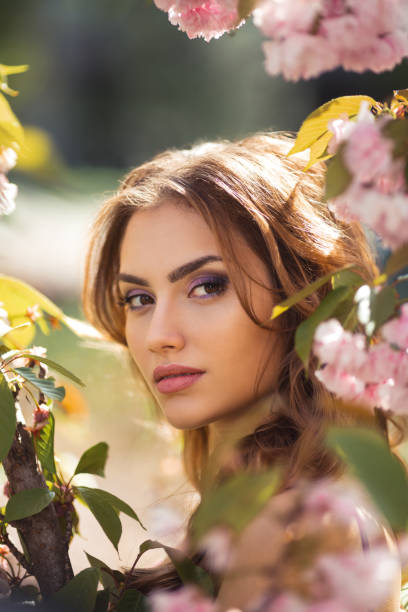 istock Woman at Blossoming Sakura Tree on Nature 1210919205
