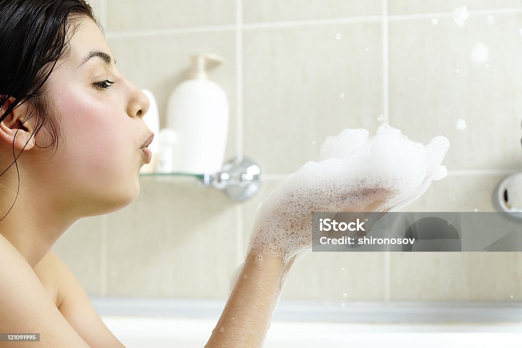 Foam play Pretty girl having fun with foam in bath Adult Stock Photo