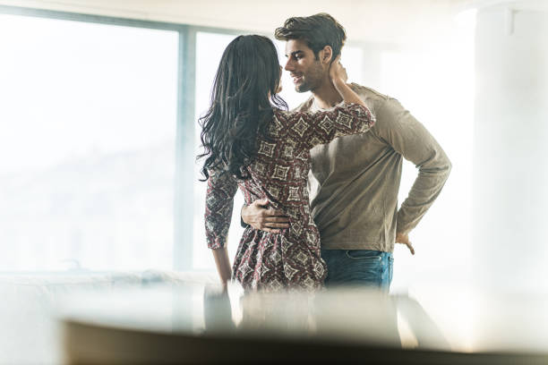istock Young couple in love having a romantic moment at home. 1210922821