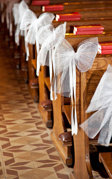 istock White bows in Catholic Church. 121092367