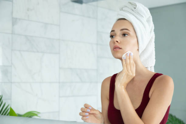 istock Woman applying cleansing tonic mirror reflection 1210923849