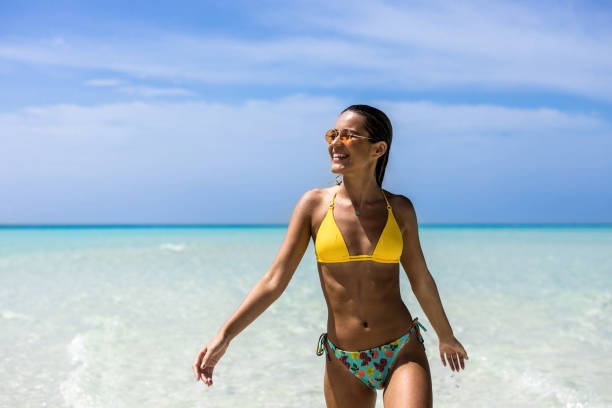 istock Young happy woman having fun while running on the beach. 1210923857