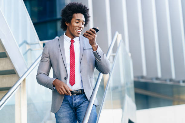 istock Black Businessman using a smartphone near an office building 1210923964