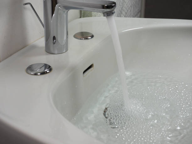 istock tap faucet in basin 1210924753
