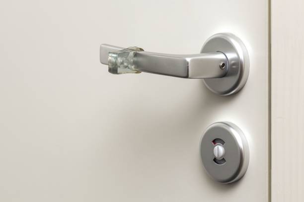 istock Close up view of lock and handle buffer rubber on white door. Interior design. Beautiful backgrounds. 1210924807