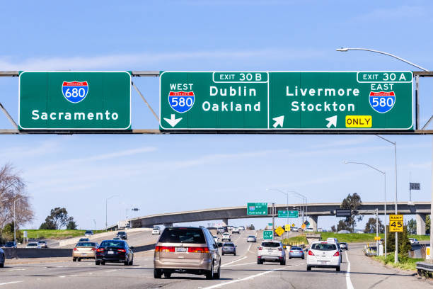 Freeway interchange in East San Francisco Bay Area Feb 17, 2020 Pleasanton / CA / USA - Freeway interchange in East San Francisco Bay Area; Signs towards Sacramento, Oakland, Stockton and other destinations, guiding drivers in choosing the right lane stockton california stock pictures, royalty-free photos & images