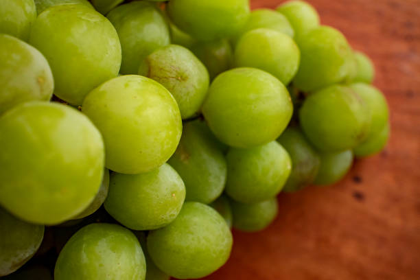 istock Deliciousgrapes on a wooden plate 7 1210927573