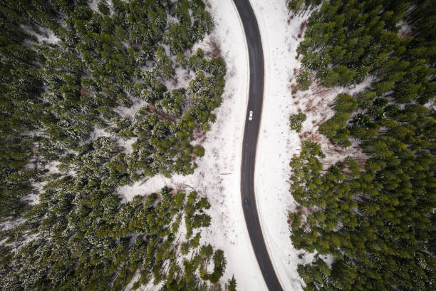 istock Flight over the winter mountains with road serpentine 1210928492