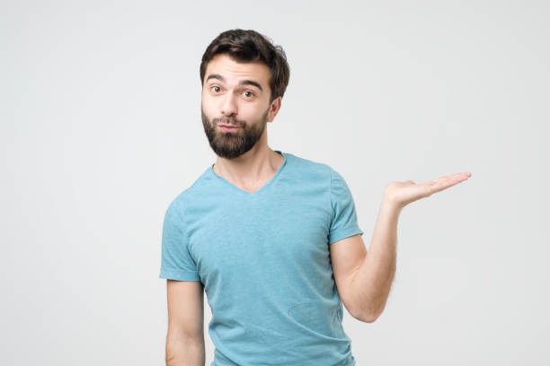 istock Young hispanic man shows something on palm 1210930628